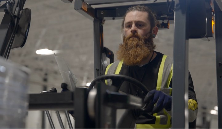 Dock worker operating forklift